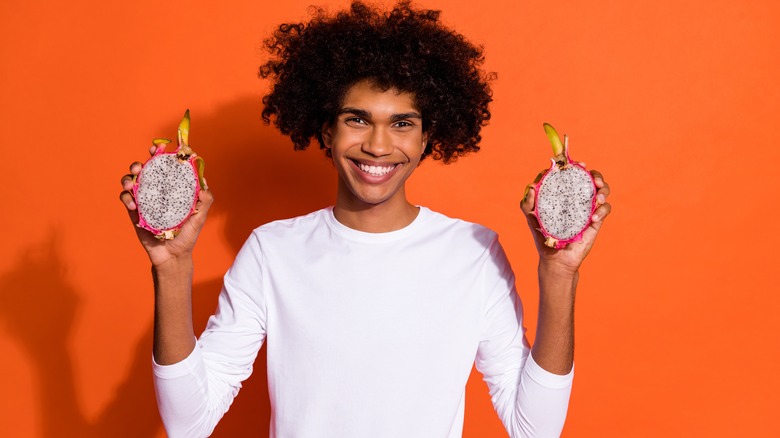 Man holding dragon fruit