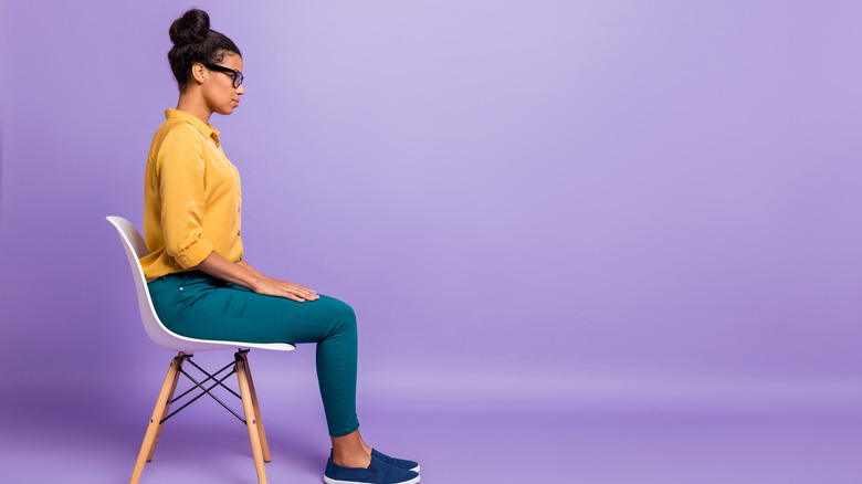 woman sitting tall in a chair