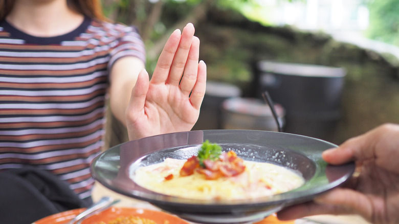 woman saying no to food