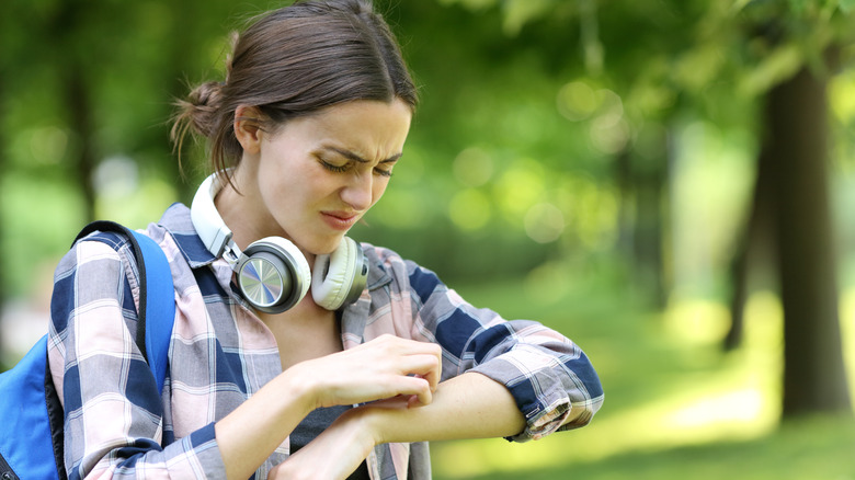 Woman scratching a mosquito bite