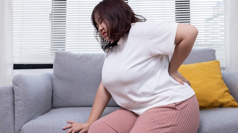 Woman on couch with chronic pain