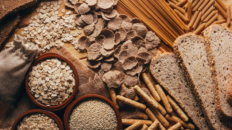 Whole grain foods on a brown cutting board