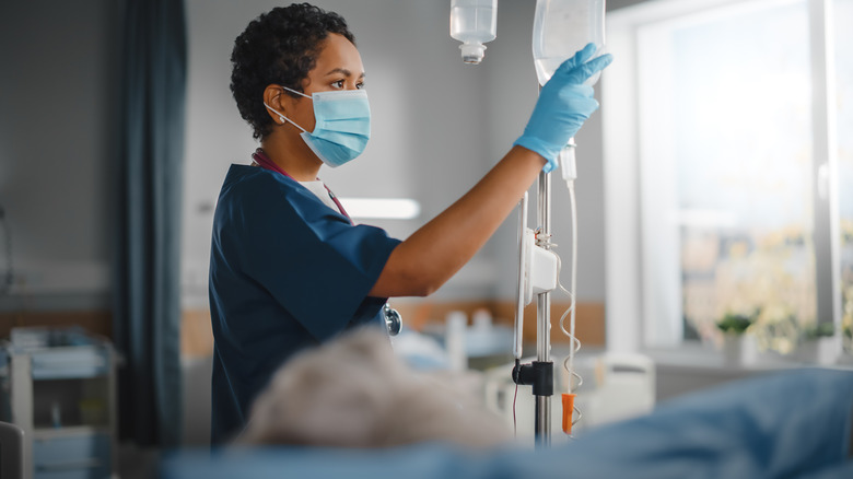 woman checking IV at hospital