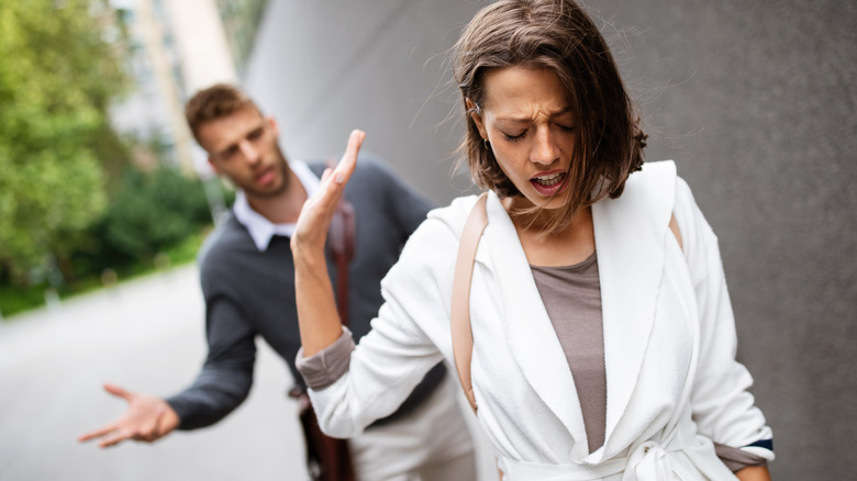 woman brushing off her husband in contempt