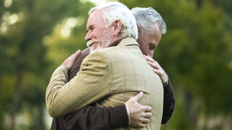 Two old men hugging