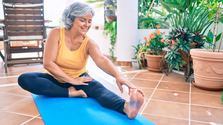 Woman stretching on yoga mat