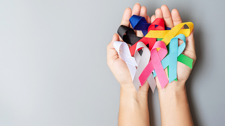 hands holding cancer ribbons