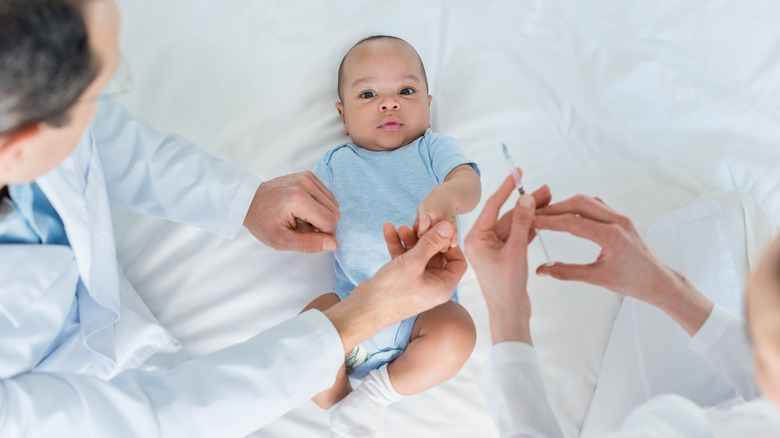 doctor preparing baby's vaccination