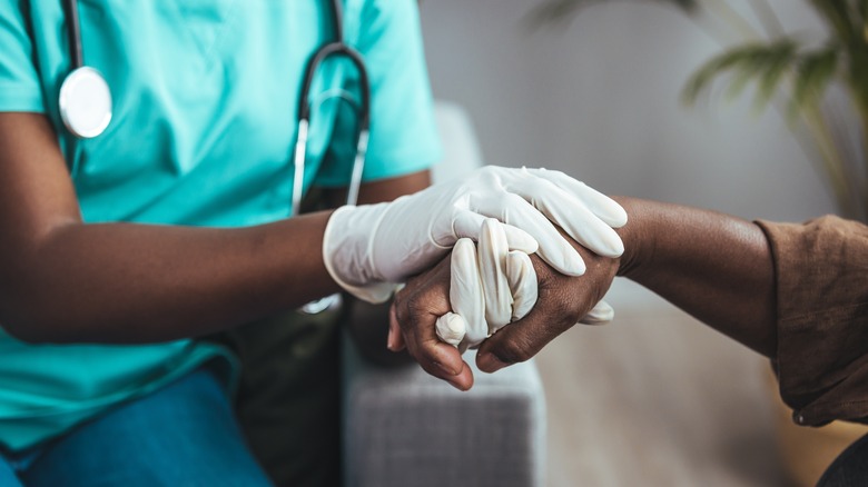 A nurse supporting a patient