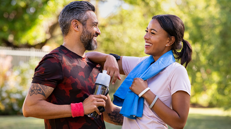 Man and woman smiling and exercising
