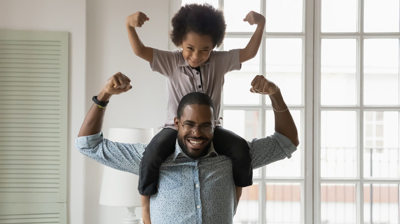 Father and son flexing muscles