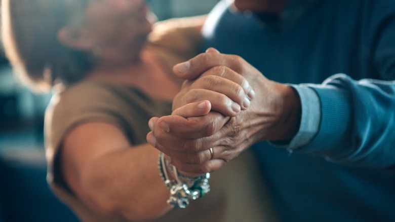 Senior couple dancing holding hands