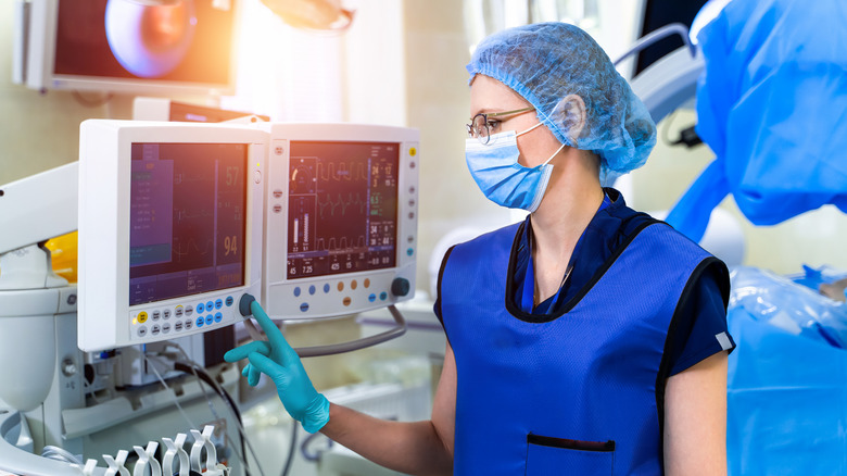 Nurse operating ventilator