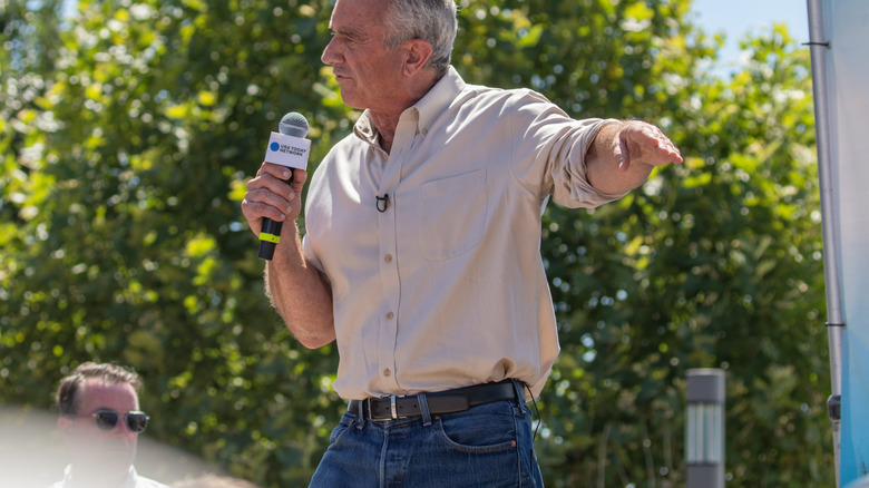 Robert F. Kennedy Jr. talking into mic wearing jeans