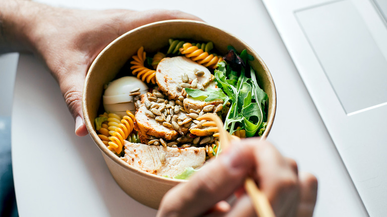 A healthy bowl of pasta, chicken, and vegetables
