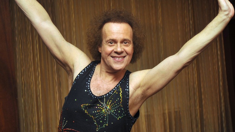 Richard Simmons smiling while wearing a glittery leotard