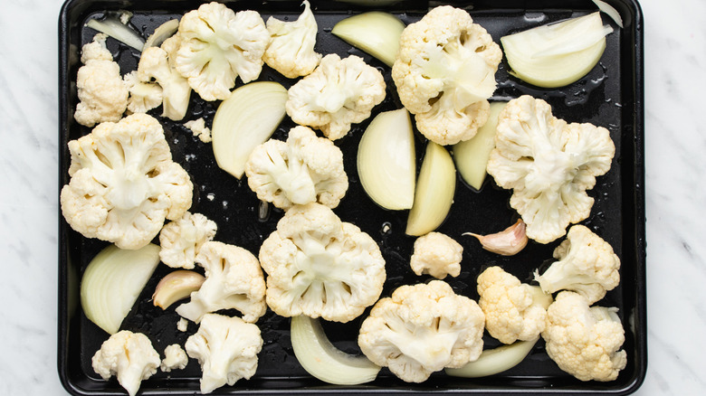 cauliflower onions on baking sheet