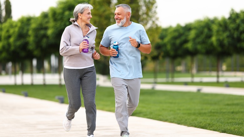 Happy older adult couple running