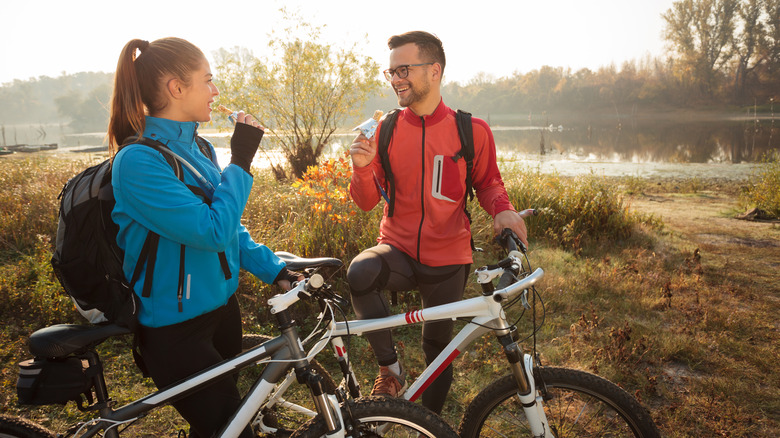 A couple stops for a snack on a bike ride