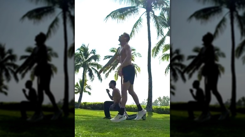 Ryan Seacrest performing lunge squats in a park