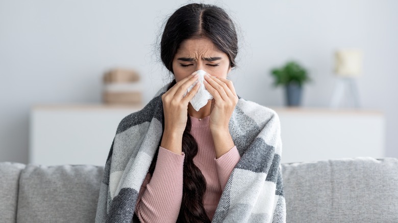 woman blowing nose