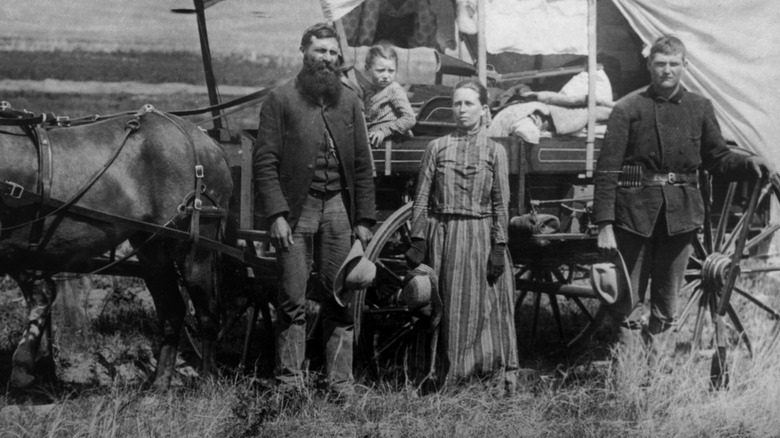 A black-and-white photo of a family moving out West to become settlers