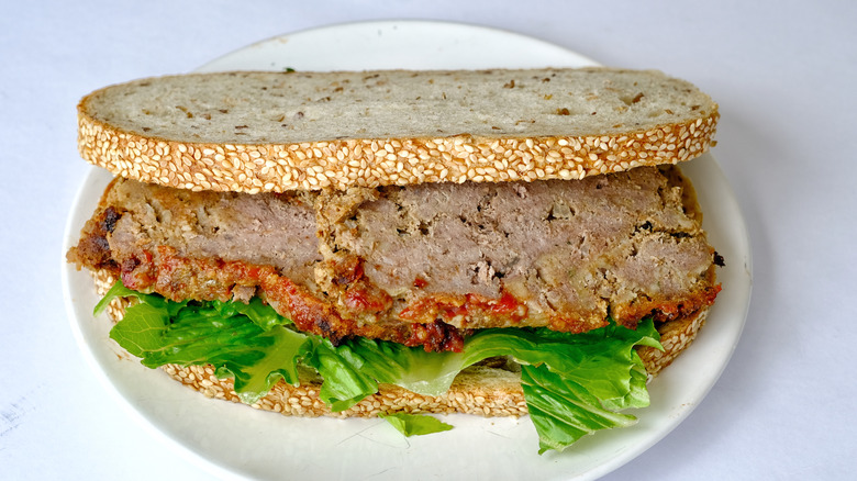 Cold meatloaf sandwich on white plate