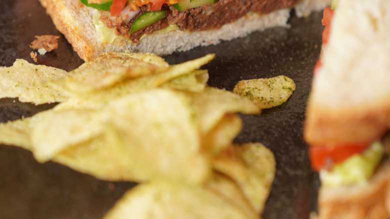 Canned sardine with tomato sauce sandwich with cucumber, tomato, and lettuce