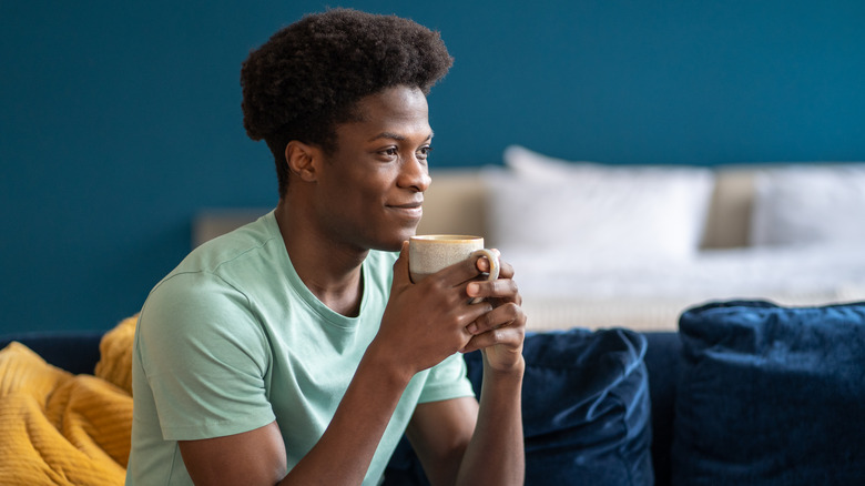 Smiling man holding tea mug