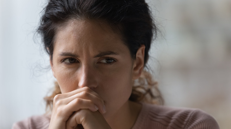 Close up a woman's worried face