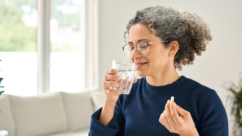 woman taking antioxidant supplement