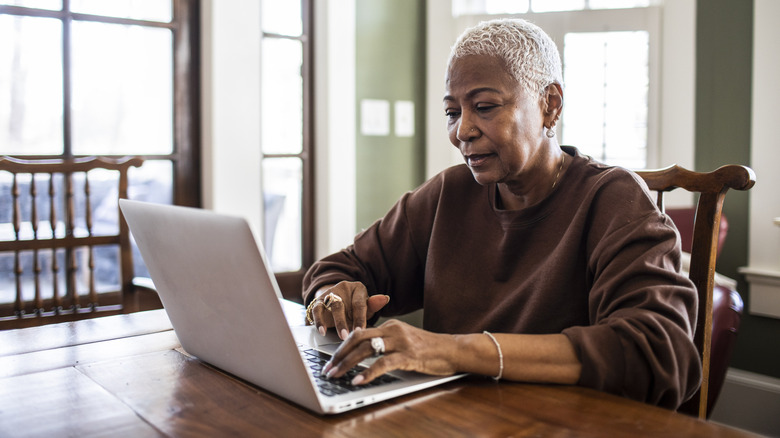 older woman working on laptop