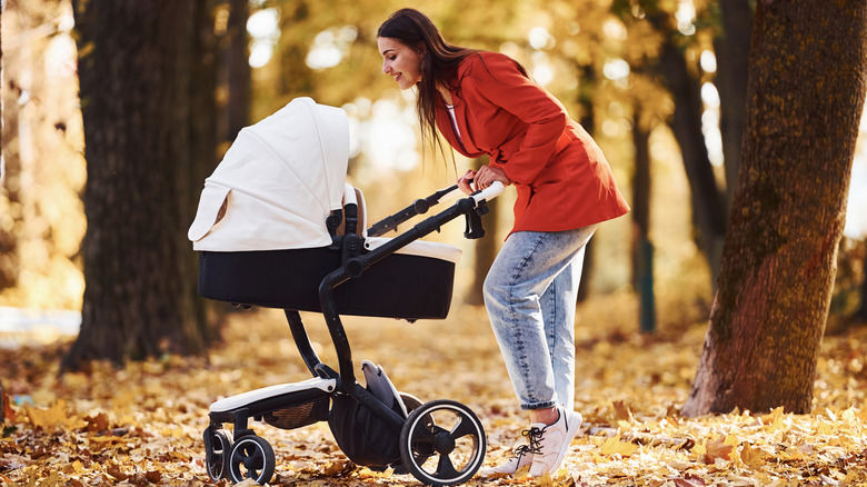 Mother walking with baby in autumn