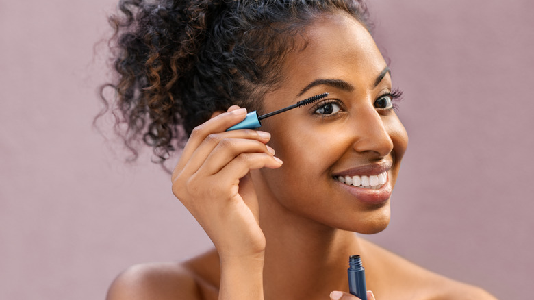 Woman applying mascara