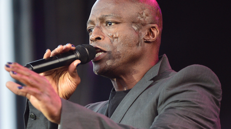 Music artist Seal singing in microphone
