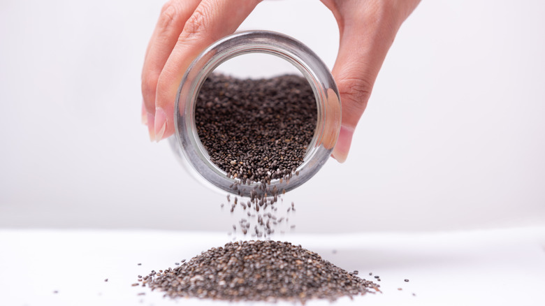 woman pouring chia seeds