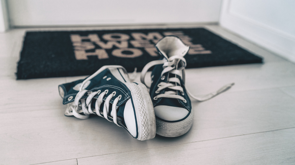 Shoes in front of doormat