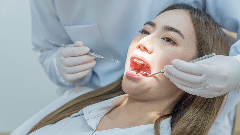 doctor examining patient's mouth