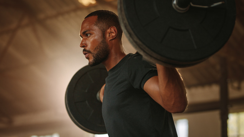 Man lifting barbell with weights