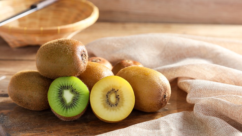 green and yellow kiwis on table