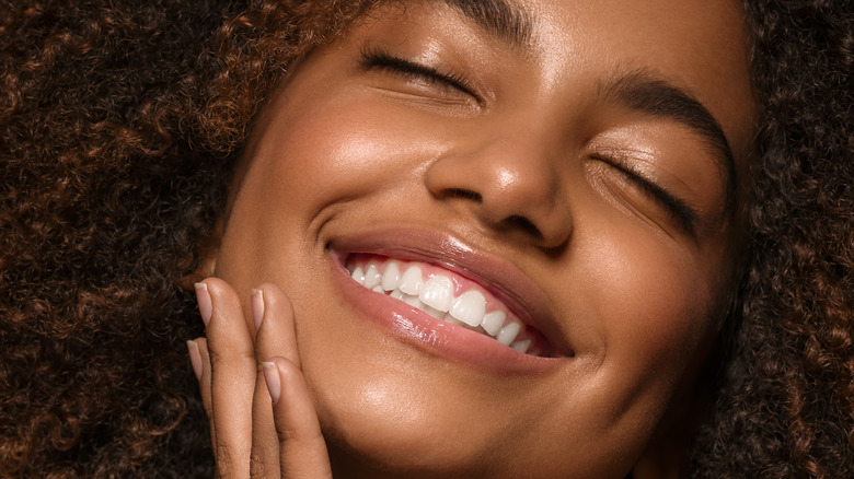 beautiful african girl smiling while showing teeth