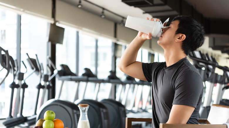 Man drinking protein shake at gym