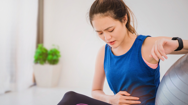 Woman working out with cramps