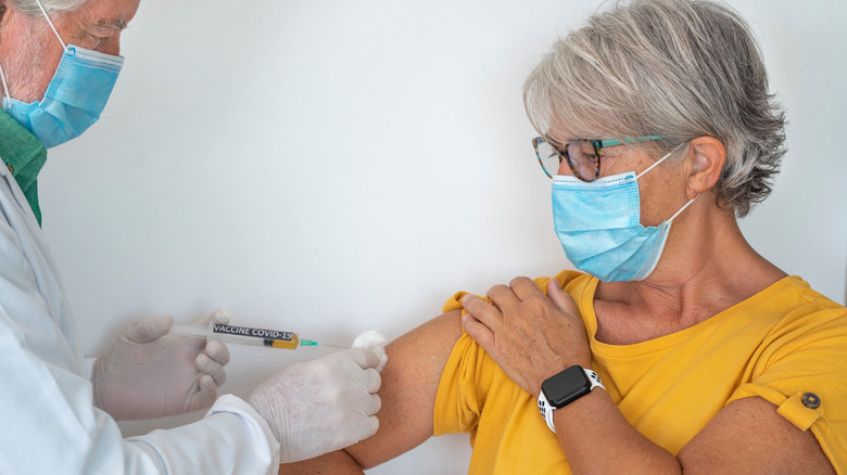 A woman gets a COVID-19 vaccine