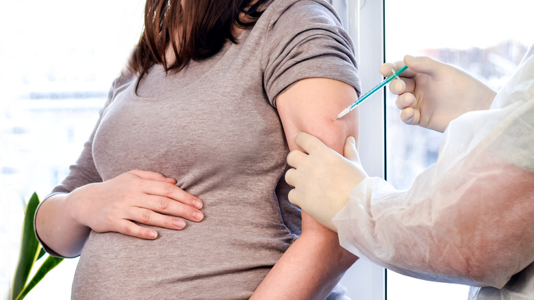 A pregnant women gets a vaccine