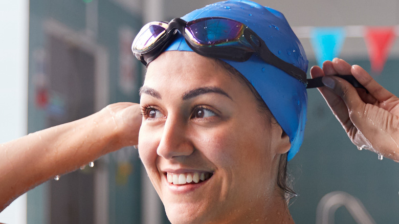 Woman adjusting goggles on her head