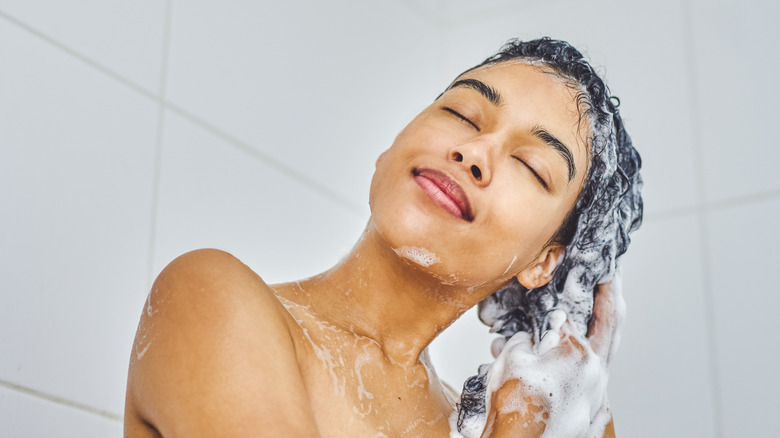 Woman showering with eyes closed