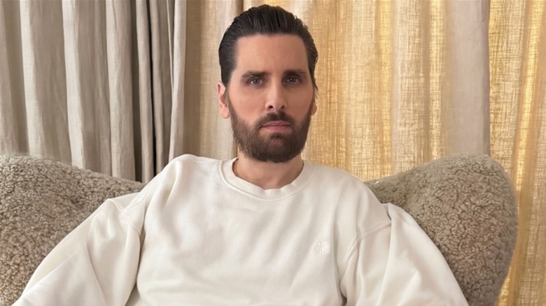 Scott disick sitting on a couch