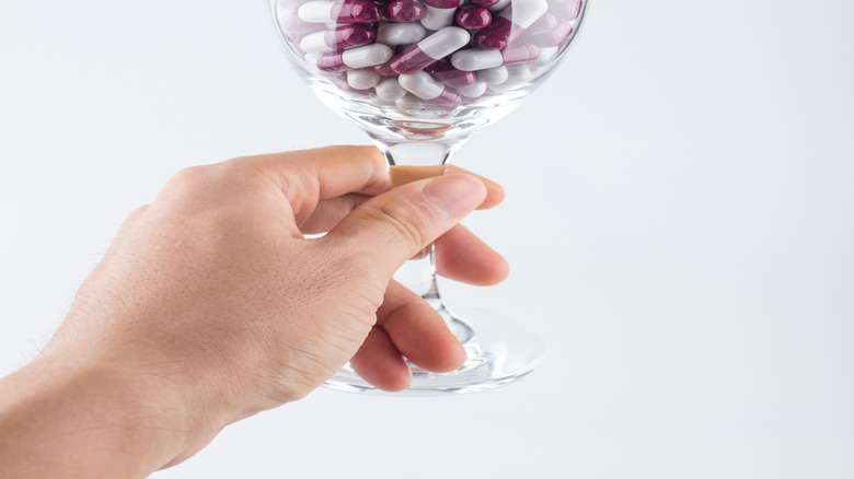 pills in wine glass