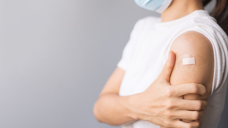 woman holding her arm in pain